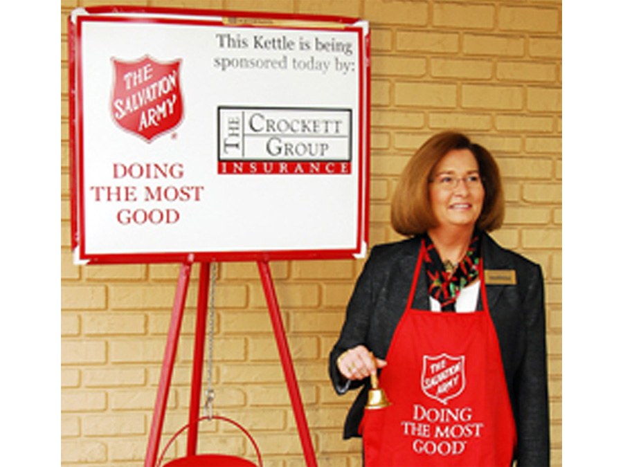 Volunteer ringing a bell for the Christmas Kettle Campaign					